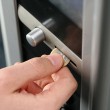 bigstock-inserting-coin-in-to-a-vending-19426934